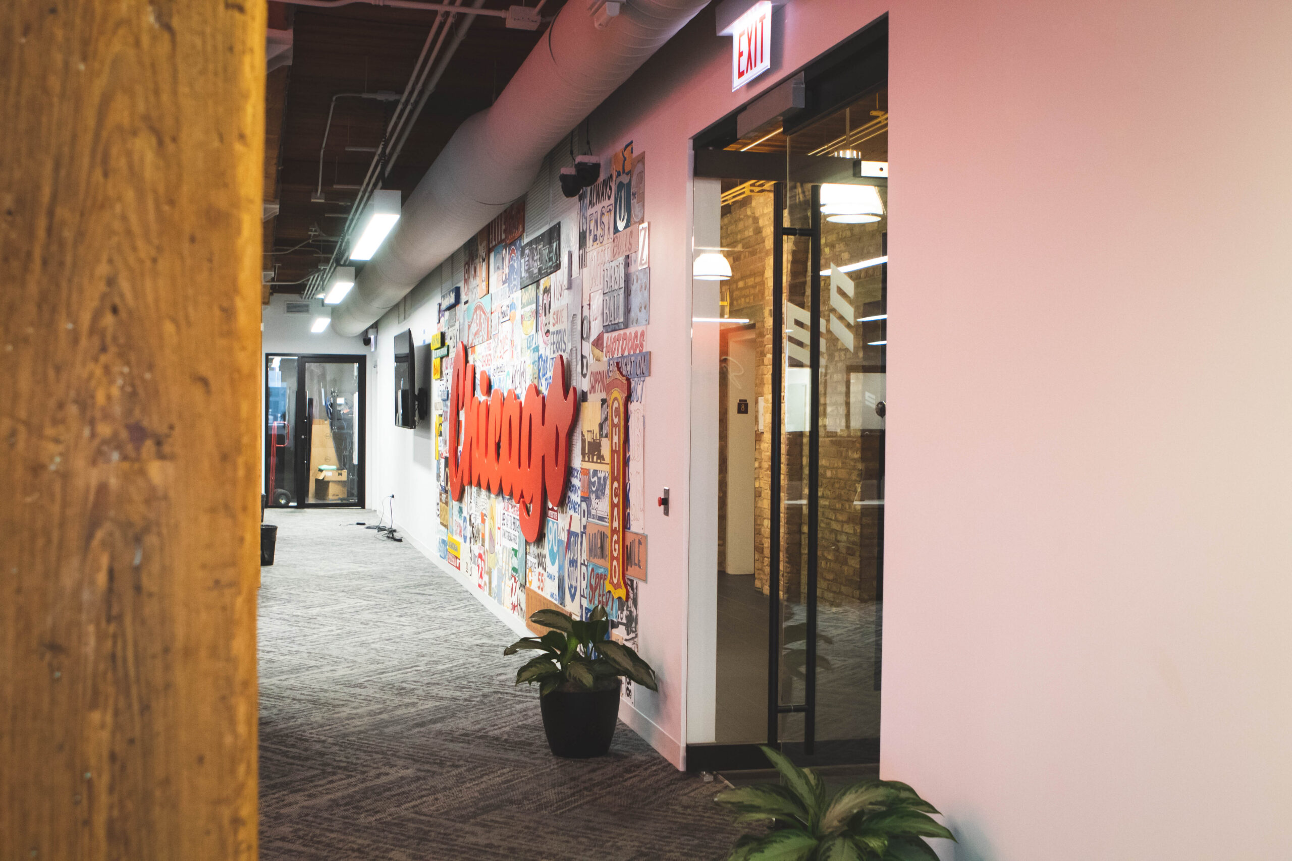 ELITE Transit Solutions Chicago office with loft style beam in the foreground and Chicago mural in the background.